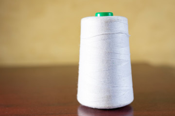 Spool of thread on the table