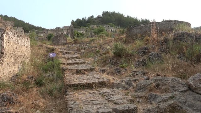 Kayakoy, Fethiye, Turkey - 12th of June 2019: 4K Stairs up the hill in the Kayakoy ruins