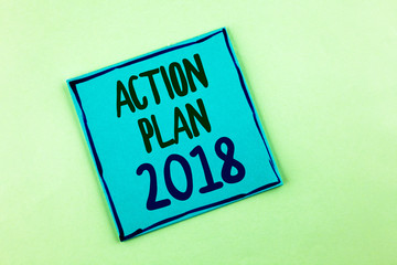 Conceptual hand writing showing Action Plan 2018. Business photo showcasing to do list in new year New year resolution goals Targets written Sticky Note Paper the plain background.
