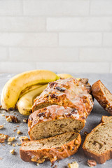 Homemade banana bread with walnuts, gray stone concrete background copy space, Vegan food.