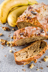Homemade banana bread with walnuts, gray stone concrete background copy space, Vegan food.