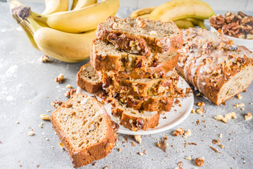 Homemade banana bread with walnuts, gray stone concrete background copy space, Vegan food.