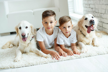 Children with a dog. Happy family with a dog to themselves at home.