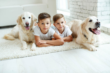 Children with a dog. Happy family with a dog to themselves at home.