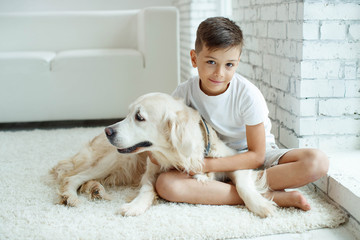 A child with a dog. Teen boy with a dog at home. 