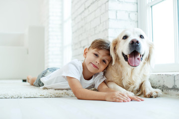 Children with a dog. Little boy at home with a dog. 