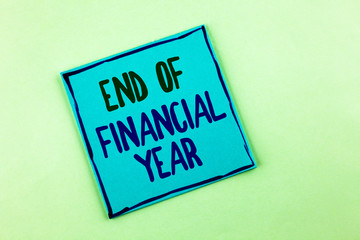 Conceptual hand writing showing End Of Financial Year. Business photo showcasing Taxes time accounting June database cost Sheets written Sticky Note Paper the plain background.