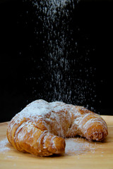 icing sugar falling  on Croissant