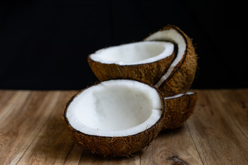 Raw fresh coconut on wooden background.