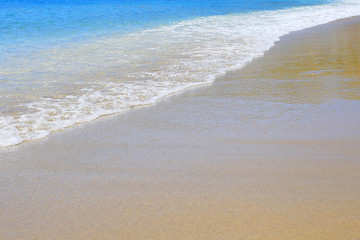 Fototapeta na wymiar Wave on sandy beach background