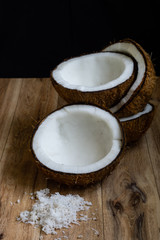 Raw fresh coconut on wooden background.