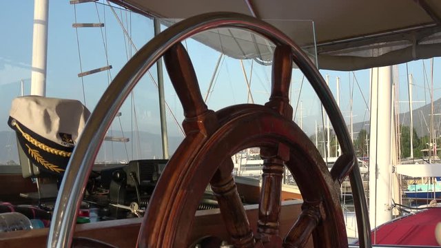 Ece Marina, Fethiye, Turkey - 11th of July 2019: 4K Sunset tour on the board of Seaside - At the wheel of unberthing ship