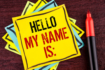 Handwriting text Hello My Name Is. Concept meaning meeting someone new Introduction Interview Presentation written Yellow Sticky note paper wooden background Marker next to it.