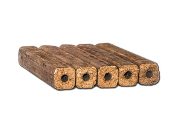 Fuel briquettes folded in rows on a white background.