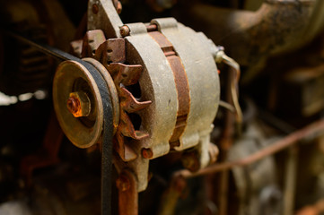 old serpentine drive belt for motor on alternator pulley on automobile engine