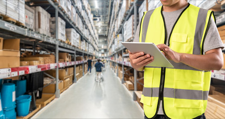 worker hand holding pad for check order pick time in smart factory warehouse