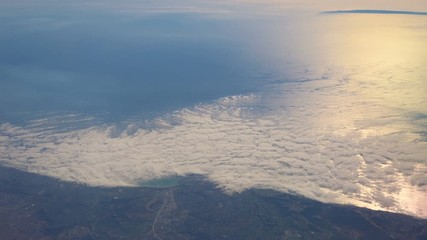 Flight in the clouds above the ocean in 4K 