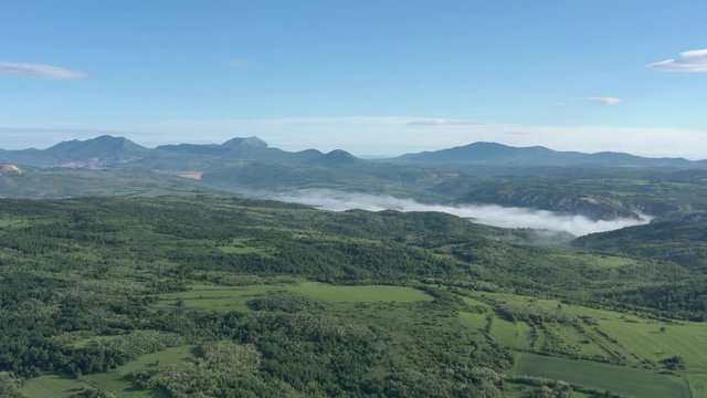 Spring scene with Veliki Krsh Deli Jovan and Stol mountains under blue sky 4K aerial video