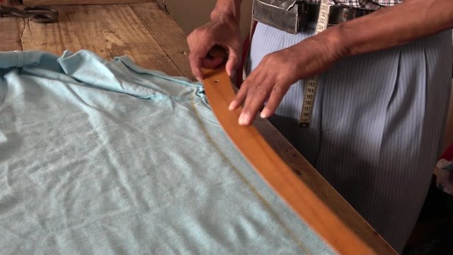 Yesiluzumlu village, Mugla, Turkey - 71th of July 2019: 4K Hands of a tailor remodeling clothes