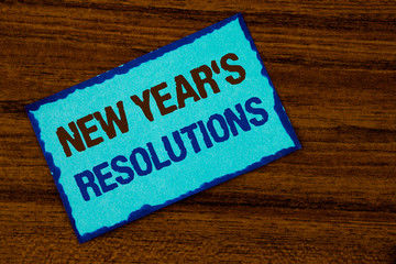Text sign showing New Year'S Resolutions. Conceptual photo Goals Objectives Targets Decisions for next 365 days written Sticky note paper the Wooden background.