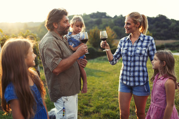 Picture of people tasting red wine in vineyard