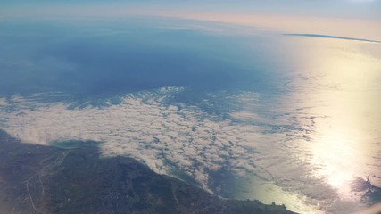 Flight in the clouds above the ocean in 4K 
