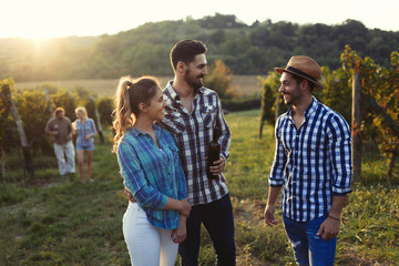 Picture of people tasting red wine in vineyard