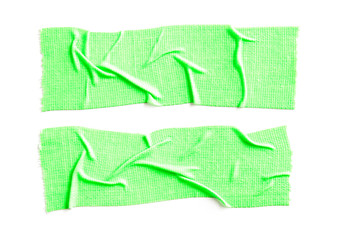 Two pieses of crumpled green fluorescent cloth gaffer tape isolated on white background.