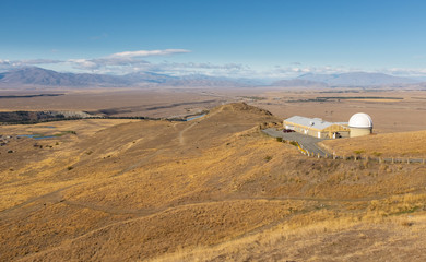Sweeping views of the spectacular golden Mackenzie Basin from the top of Mt John including Lake Tekapo