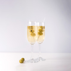 Champagne glasses with olive isolated on white background