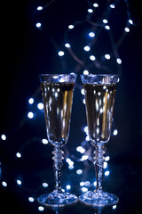 Glass with champagne on dark backdrop at nightclub