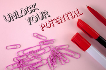 Writing note showing Unlock Your Potential. Business photo showcasing Reveal talent Develop abilities Show personal skills written plain Pink background Pen Marker and Paper Pins next to it.