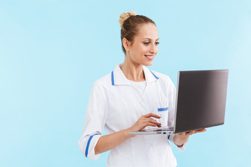 Beautiful blonde woman doctor wearing uniform standing