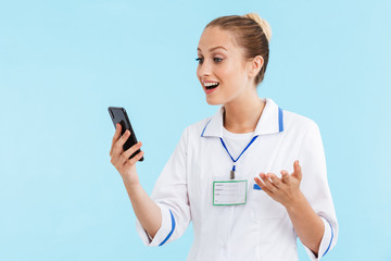 Fototapeta premium Beautiful blonde woman doctor wearing uniform standing