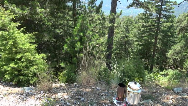 Nif, Mugla, Turkey - 71th of July 2019: 4K Tilt up making tea off the road in the pine forest