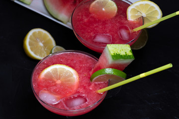 Close-up of watermelon cocktail with a slice of lemon and watermelon
