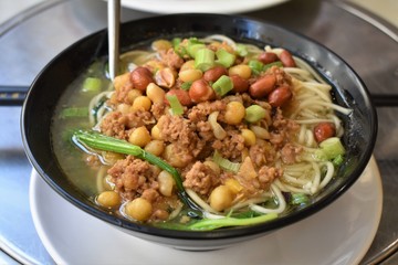 “Dan dan” noodle soup with chives, pork, chickpeas and peanuts. Sichuan cuisine dish