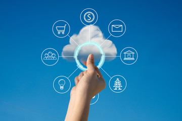 Concept of download on cloud storage.Woman hand holding picture on cloud sky background. The development of the imagination, copy space.
