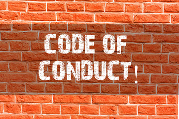 Fototapeta na wymiar Writing note showing Code Of Conduct. Business concept for Follow principles and standards for business integrity Brick Wall art like Graffiti motivational call written on the wall