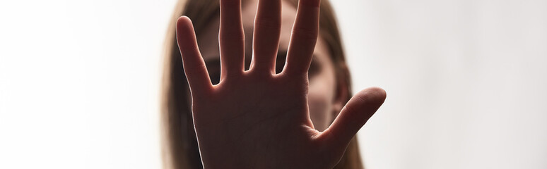 panoramic shot of victim of bullying showing stop sign isolated on white