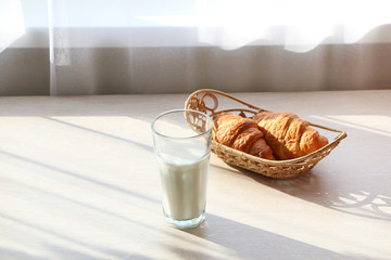 Healthy breakfast with croissant and milk.