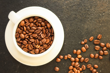 coffee beans (good and bad grain) - arabica and robusta blend (roasted coffee grain). Black background. Top view. Copy space