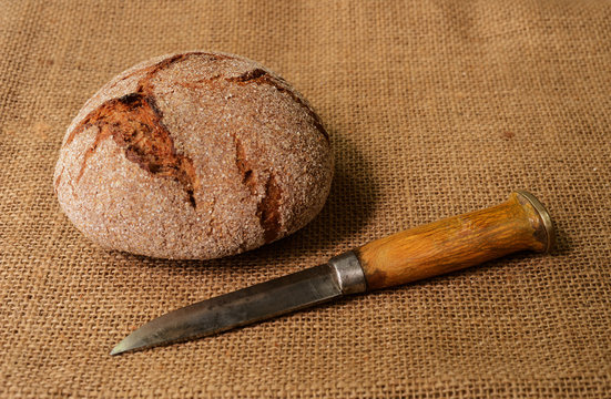 traditional finnish rye bread on burlap and finnish knife puukko