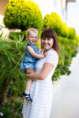 portrait of beautiful young mother with cute happy daughter