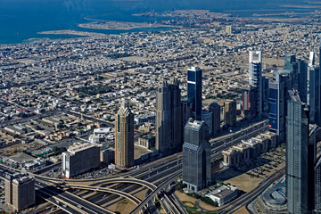 Fototapeta na wymiar Downtown skyscrapers and highways in modern Dubai City, with the old city in the background