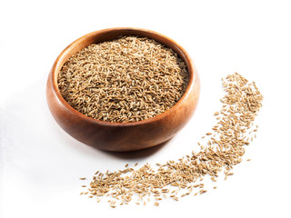 Cumin seeds (Cuminum), jeera in wooden cup on a white background
