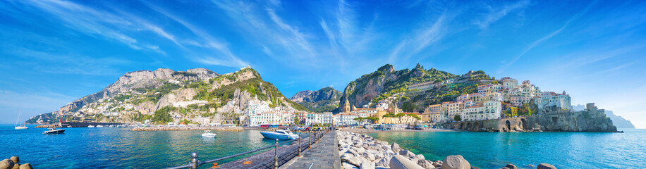 Panorama of Amalfi on hills leading down to coast, comfortable beaches and azure sea on Amalfi...
