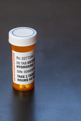 Prescription bottle with backlit Oxycodone tablets. Oxycodone is a generic prescription opioid. A concept of the opioid epidemic crisis