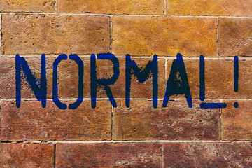 Conceptual hand writing showing Normal. Concept meaning conforming to a standard Usual Typical or...