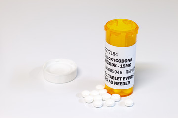 Prescription bottle with Oxycodone tablets isolated on a white background. Oxycodone is a generic prescription opioid. concept of the opioid epidemic